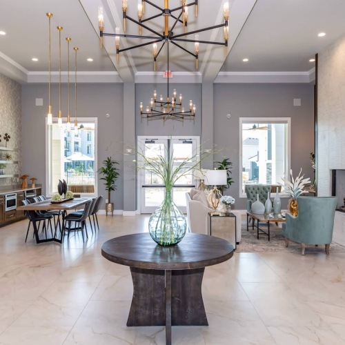 lounge and kitchen with seating and chandeliers 