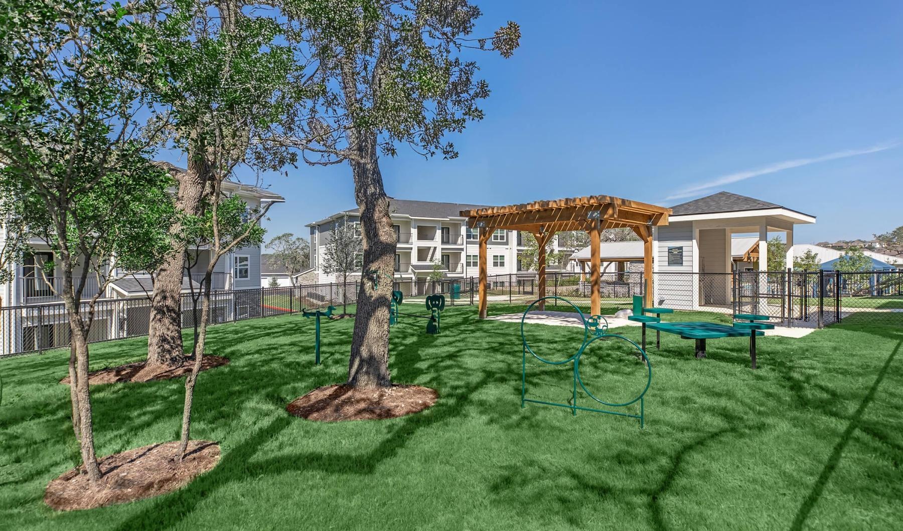 a backyard with a trampoline and trees